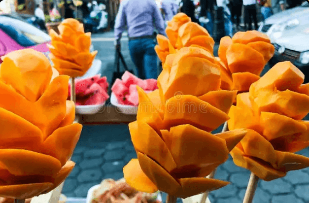 Next stop: South Asia, where mango is not just a fruit but royalty. In the busy lanes of Old Delhi where rickshaws buzzed and spices filled the air Manggaman discovered a small kulfi cart with a long line - always a good sign. That was the reason for the next mango revelation for Manggaman and it came in the form of Mango Kulfi. The frozen dessert on a stick was a denser and creamier version of traditional mango ice cream. The slow-cooked milk combined with cardamom made each bite feel like a trip down memory lane. The dessert presented on a small leaf plate while sunset bathed Manggaman in its warm light transformed into a memorable experience. Manggaman ended his journey with a soothing cup of dense mango lassi mixed with yogurt and sprinkled with pistachios.